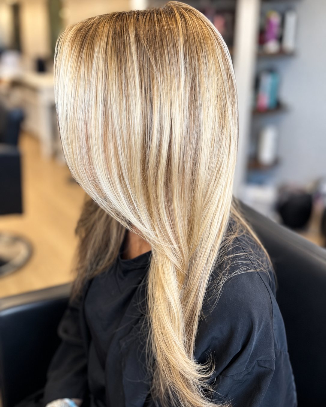 Long blonde hair with bright ribboned highlights and soft root